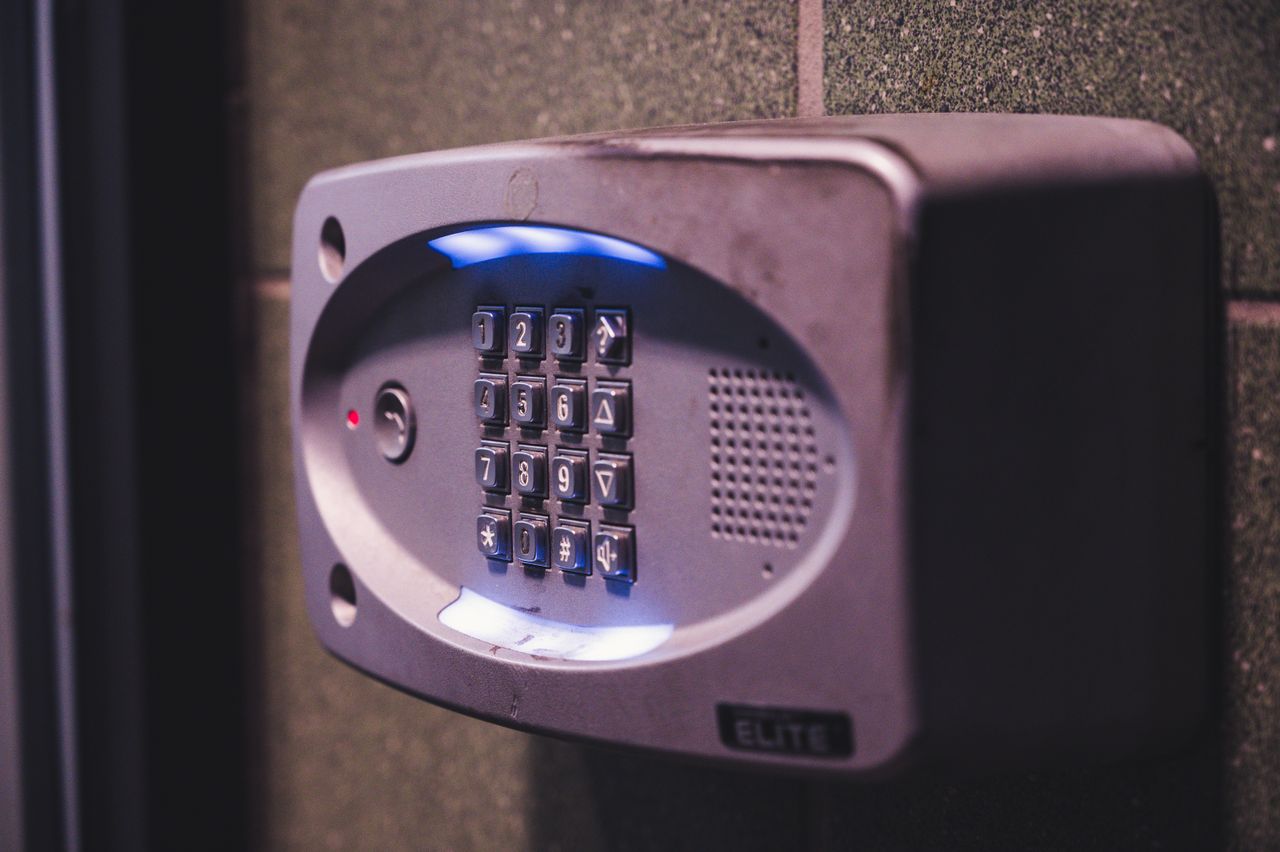 gallery-4 A close-up image of an illuminated security keypad mounted on a wall.