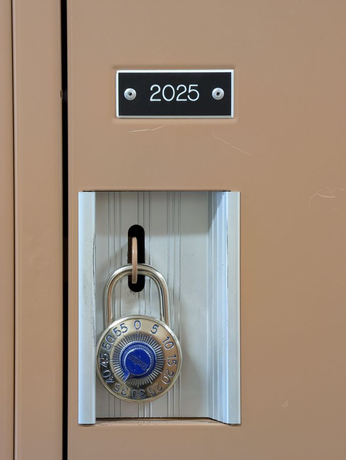 gallery-3 Close-up of a combination lock securing a beige locker labeled 2025.